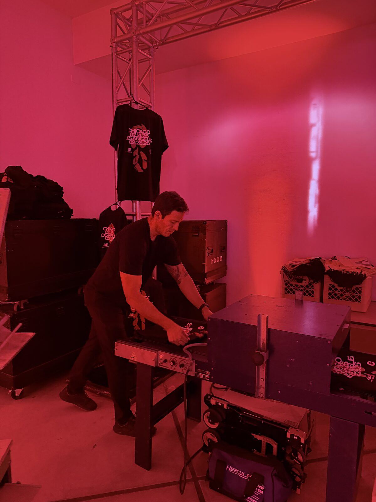 Live DTF printing station set up at an event with heat press and finished garments
