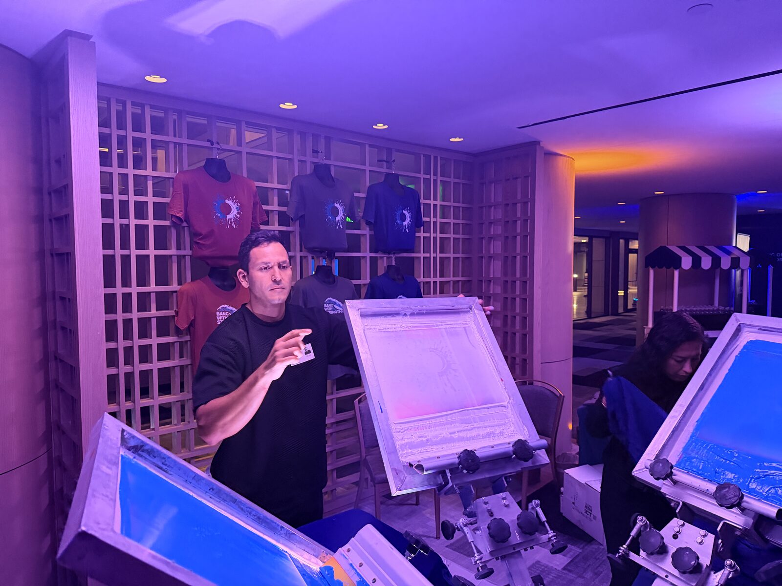 Live printing presses running at an evening event activation